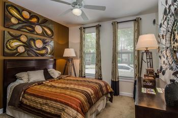 Cozy bedroom with large windows for natural lighting at Capitol Gateway in Atlanta, Georgia
